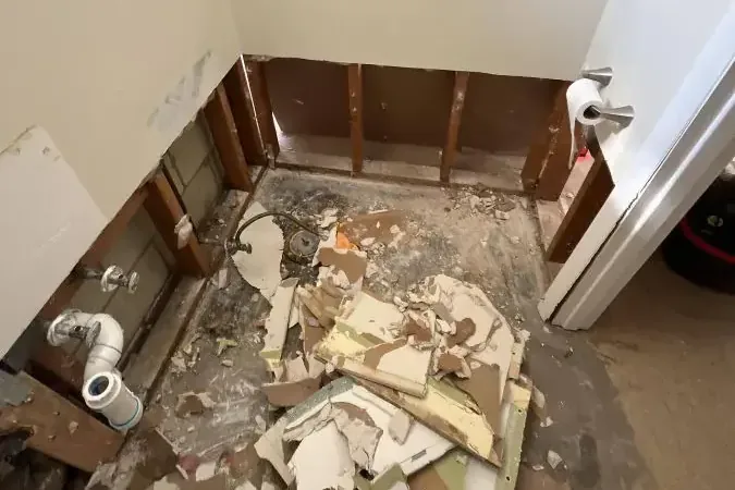 A bathroom stripped down to the studs after sewage cleanup